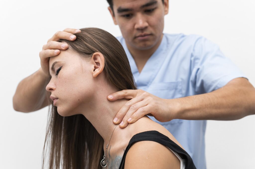 Physiotherapist massaging woman's neck