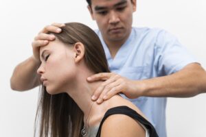 Physiotherapist massaging woman's neck