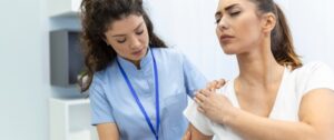 woman in pain with her doctor