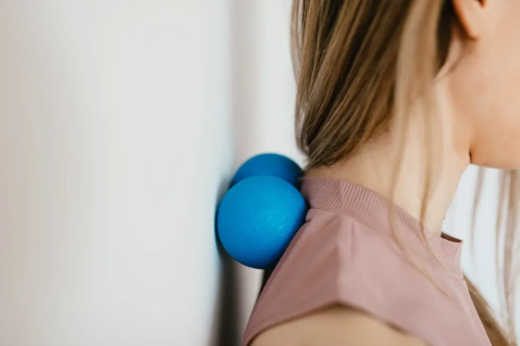 image of a woman rolling her neck with a tool